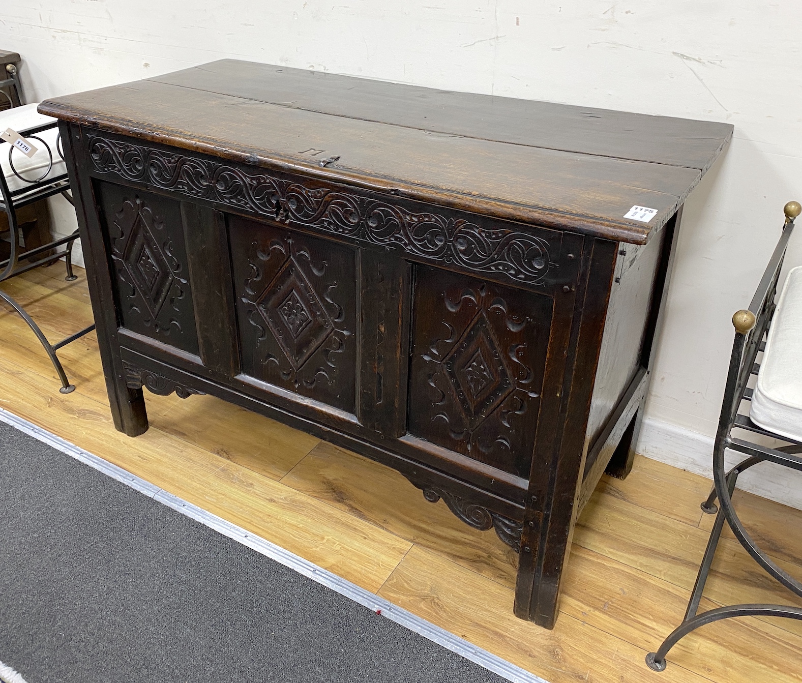 A late 17th century oak coffer the front carved with three lozenge medallion panels, length 115cm, depth 51cm, height 74cm